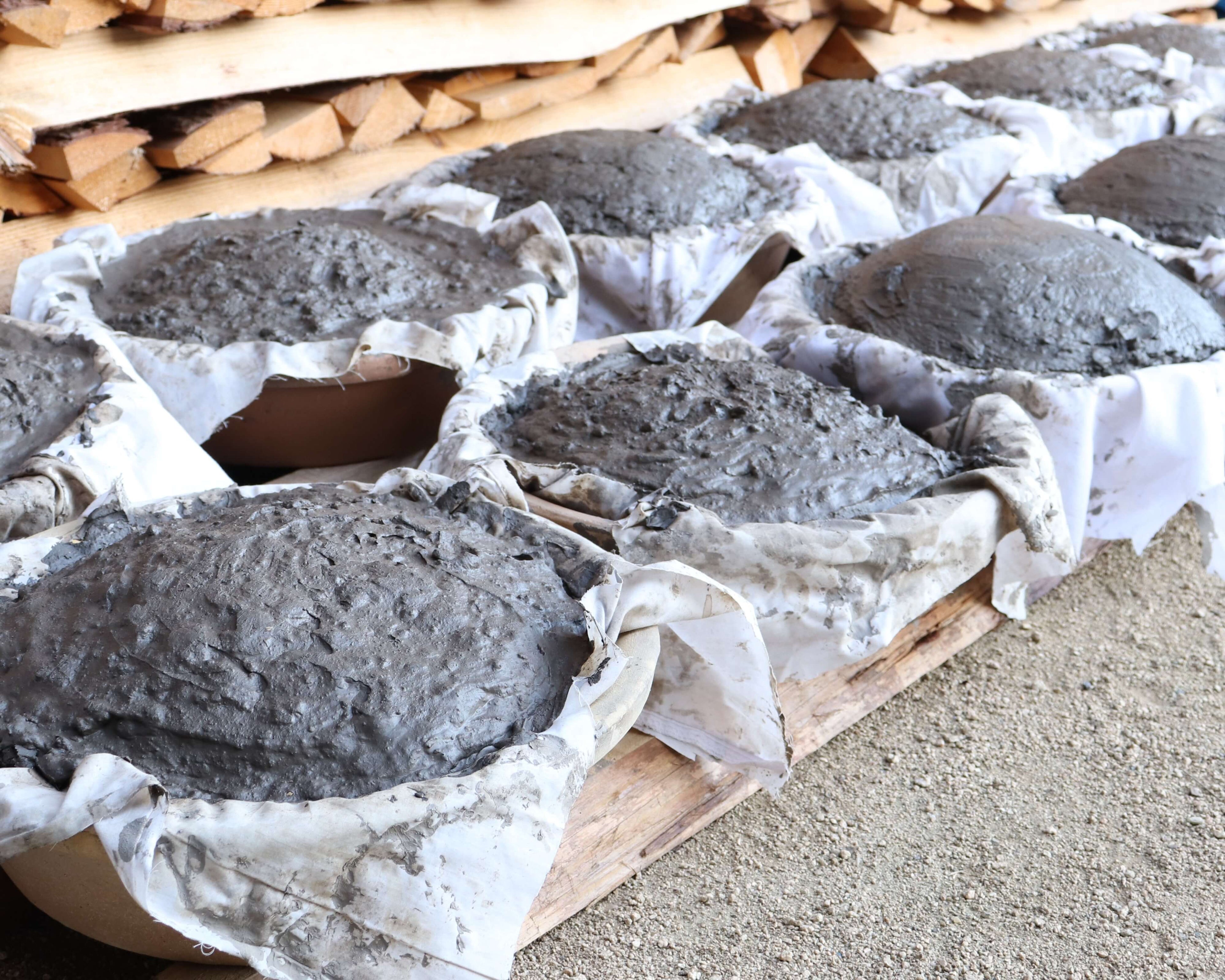 Bundles of Hiyose clay wrapped in cloth, prepared for firing