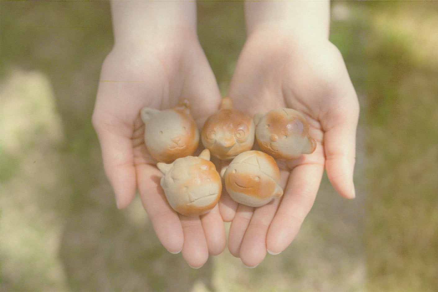 Bizen ware artist Emi Kanda holding handmade ceramic sculptures