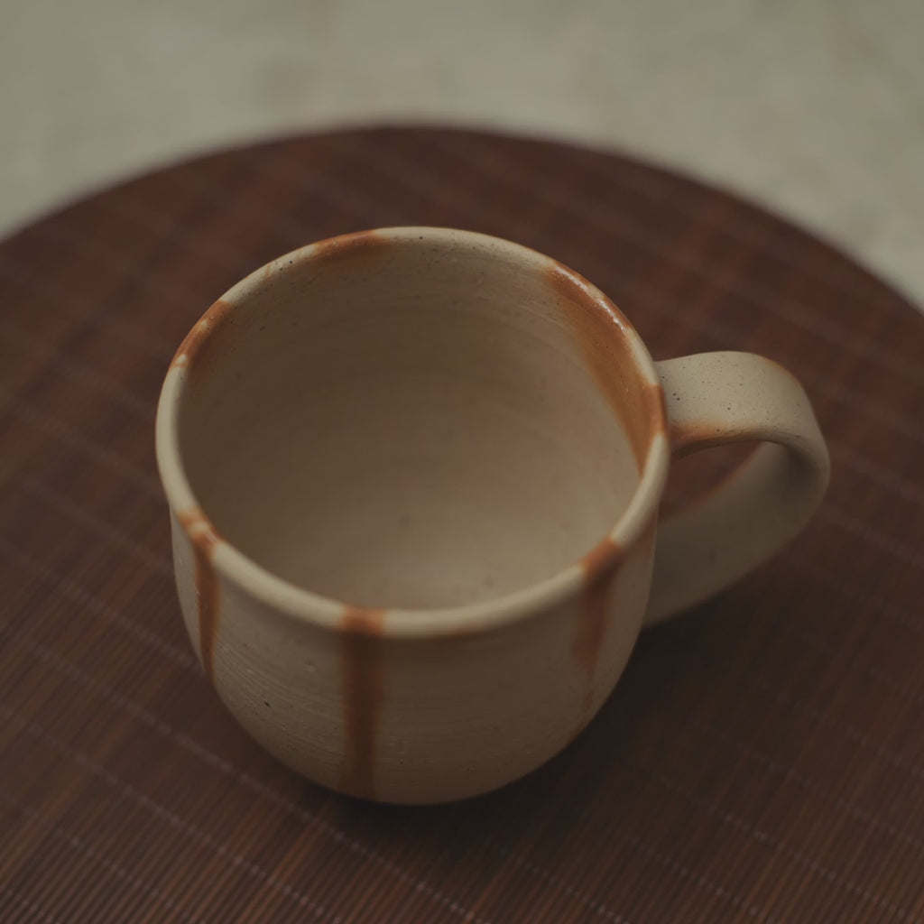 Coffee poured into handmade Bizen ware ceramic mug